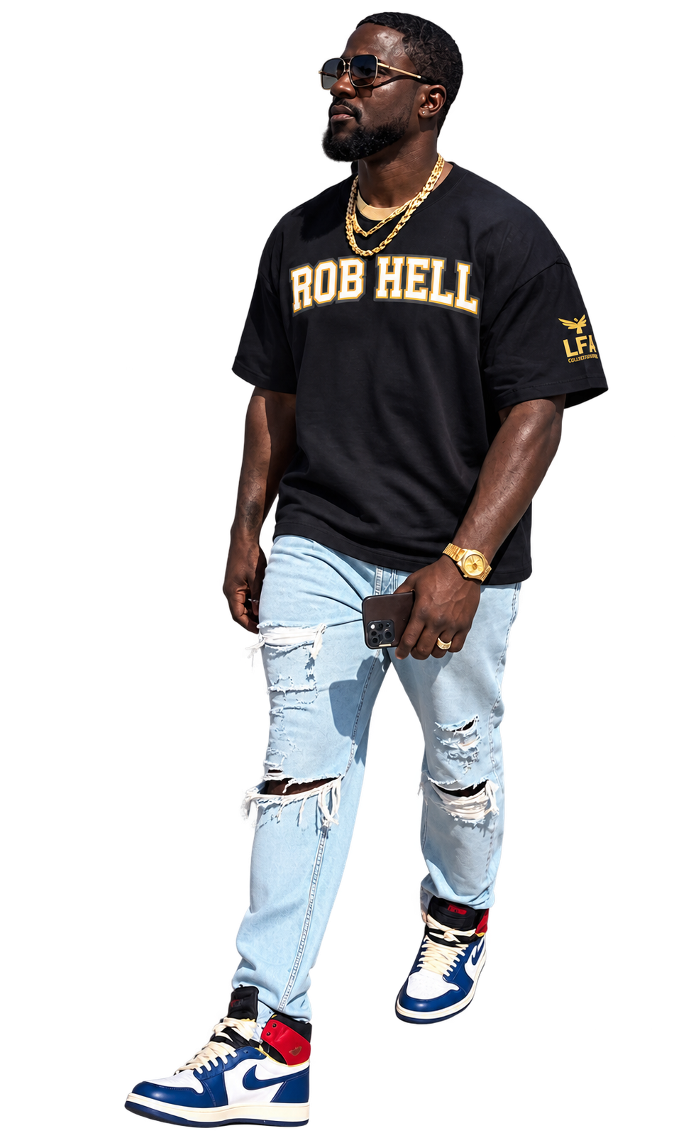 A man wearing a black t-shirt with 'ROB HELL' printed in gold across the chest, light-wash ripped jeans, blue and white sneakers, and gold jewelry, set against a solid white background.